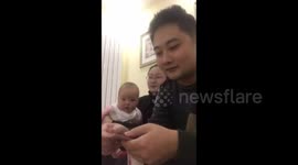 Baby can't stop laughing at dad counting money