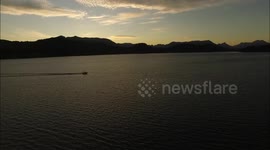 Strangely peaceful footage of a boat returning to harbour at sunset