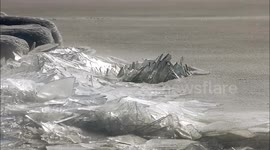 Lake Superior's crackling ice stacking looks like a pile of broken glass in this mesmerising footage