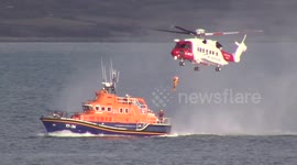 Coastguard pilot shows off skills as they winch man from boat in exercise