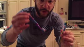 Man lifts gym weights with two toothbrushes