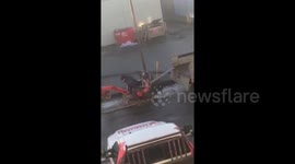 Workman tries to load mini excavator onto truck, fails
