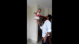 Man balances baby on his hand