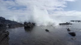Stop-motion footage of a wave wiping out some people in Hawaii