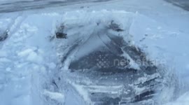 Ice sculpture in the shape of a car left behind after parked car moves