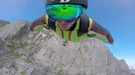 Man takes extreme selfie while wing suit flying