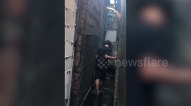 Heroic teenager wades through dirty overflowing sewage water to save trapped kitten