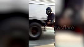 Cool unicycle rider turns heads as he speeds along road in the Philippines