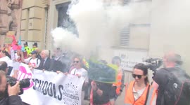 Striking teachers set off smoke bombs outside and BOO Department for Education during protest march