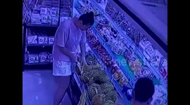 Woman sneaks a feast of durian in Chinese supermarket