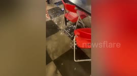 Dirty flood enters restaurant during monsoon storm in Cambodia