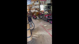 Boy does a fun front wheel balancing trick with a crazy cart