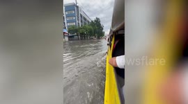 Passing bus speeds through flooded road drenching jeepney passengers in the Philippines