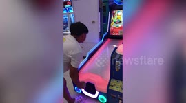 Teenager smashes arcade game display with bowling ball fail