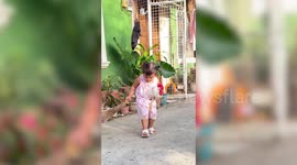 Clingy little girl cleans and plays while snuggling with favourite pet chicken