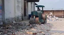 Indian excise officers steamroll thousands of bottles of illegal liquor