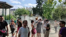 Heatwave in Paris: People enjoying the public fogger of the Jardin Villemin garden, Gare de L'Est train station. France. 8 july 2023