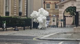Peculiar scene as woman walks down street with hundreds of white helium balloons in London