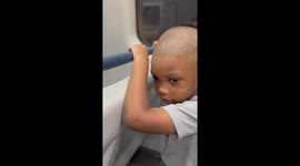 Young kid rides the train for the first time