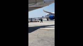Airport Worker Dances on the Tarmac