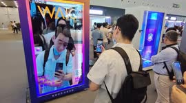 Visitors Experience Interactive Face Changing at 2023 WAIC in Shanghai, China