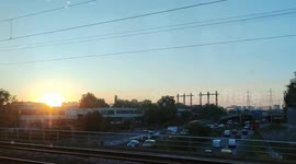 Sunset panoramic travelling view from inside train. Paris suburb, France, Le Stade station, Colombes. 11 july 2023