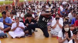 Devotees join frenzied chanting ceremony 'to ward off evil spirits' in Thailand