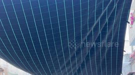 Palestinians attach shades to block the view of Israeli drones in the streets of Balata refugee camp, in the West Bank city of Nablus.