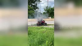 Motorcycle rider pulls over and jumps off his burning two-wheeler