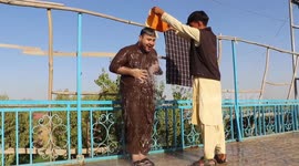 Residents of northern Afghan provinces shelter themselves from extreme summer weather