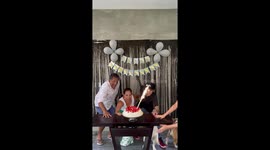 Bulldog interrupts family photo by knocking over cake