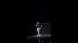 Taylor Lautner doing a backflip on stage at the Kansas City 7/7 Eras Tour