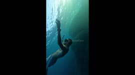 Freediver effortlessly breathes out delicate bubble rings *Underwater Spectacle!*