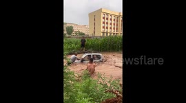 Heroic villagers rescue pair from flood-swept mobility car in China