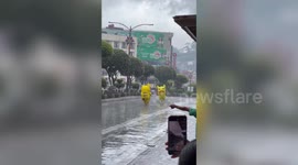 Pair of jolly Pikachu mascots dance in rain