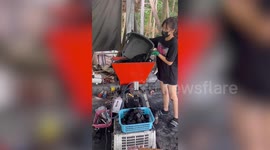 Thai woman makes charcoal bricks using machines set up in her backyard