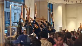 Eccentric performers dance with baguettes at Longchamp launch party in London