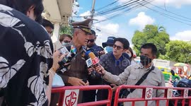 Protesters and police prepare for the demonstration later today outside the Parliament in Bangkok, Thailand. Stalls sell orange t shirts and all manner of materials in support of the leader