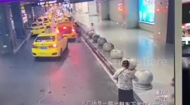 Taxi crashes through barrier into family at train station in China