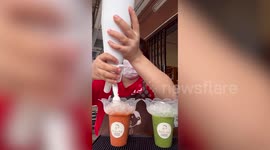 Barista adds massive toppings to customer's coffee at cafe in Thailand