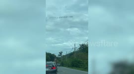 Wild elephant stops and checks out cars for food on rural road in Thailand