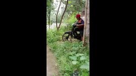 Overloaded motorbike sends friend tumbling in Yogyakarta, Indonesia
