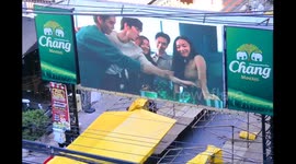Overhead view of an outdoor video advertisement for Chang brand drinks, including Chang Beer, in central Bangkok, Thailand, South East Asia.
