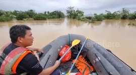 Officials use rafts to rescue stranded residents as floods take hold in Indonesia
