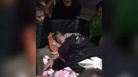 Indonesia floods: Watch moment vulnerable old lady is carried out of home in her bed