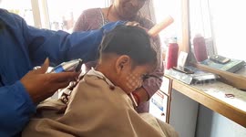 Gentle baby cutting his hair for the first time