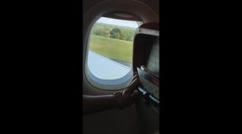 Terrifying moment passenger films Jet2 plane tipping violently towards the ground during gale-force winds at England's Birmingham Airport
