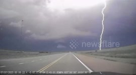 Motorist's dashcam captures lightning strikes as they drive through intense storm in Kansas