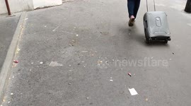 Swirl of leaves and parisian dust. Leaf whirlwind. Paris, France, rue de Tolbiac. 14 july 2023