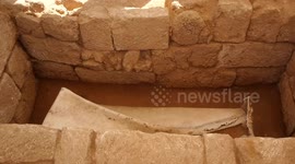 Palestinian workers inspect coffin was made of lead at the Roman cemetery in the northwest of Gaza City